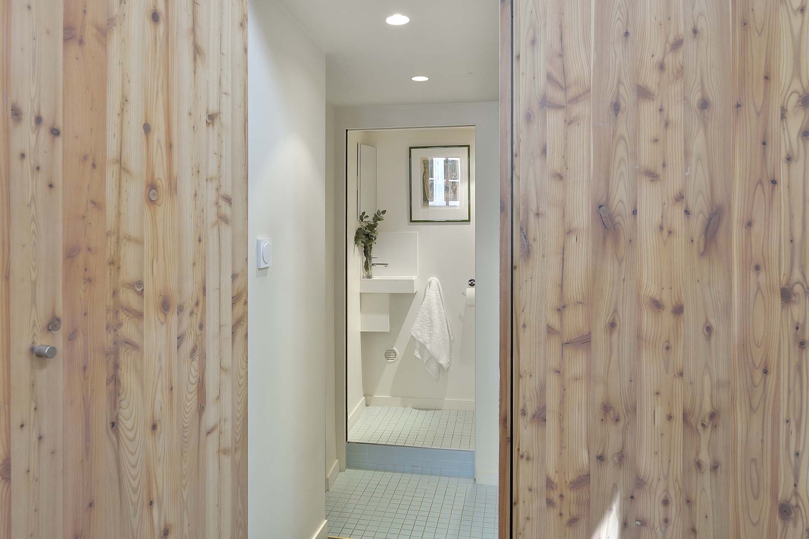 A hidden entrance through the wood paneling leads to bathroom.