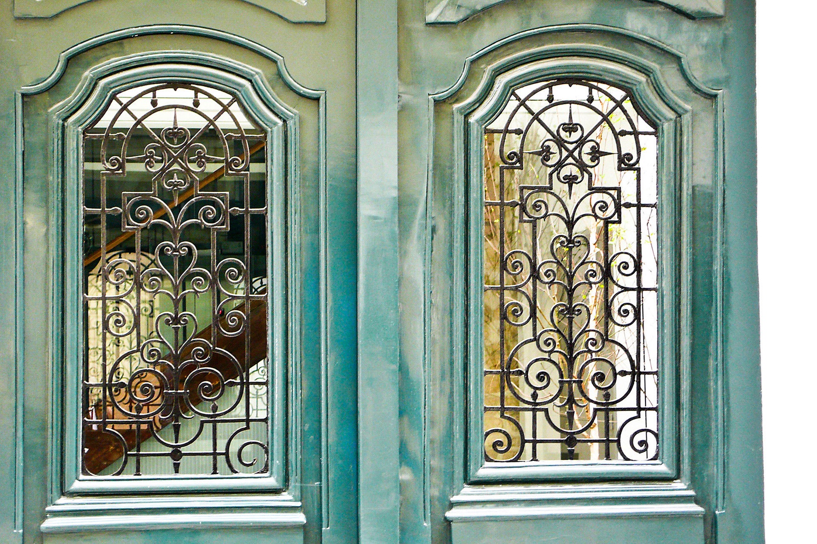 See the courtyard through the glass of these antique doors.