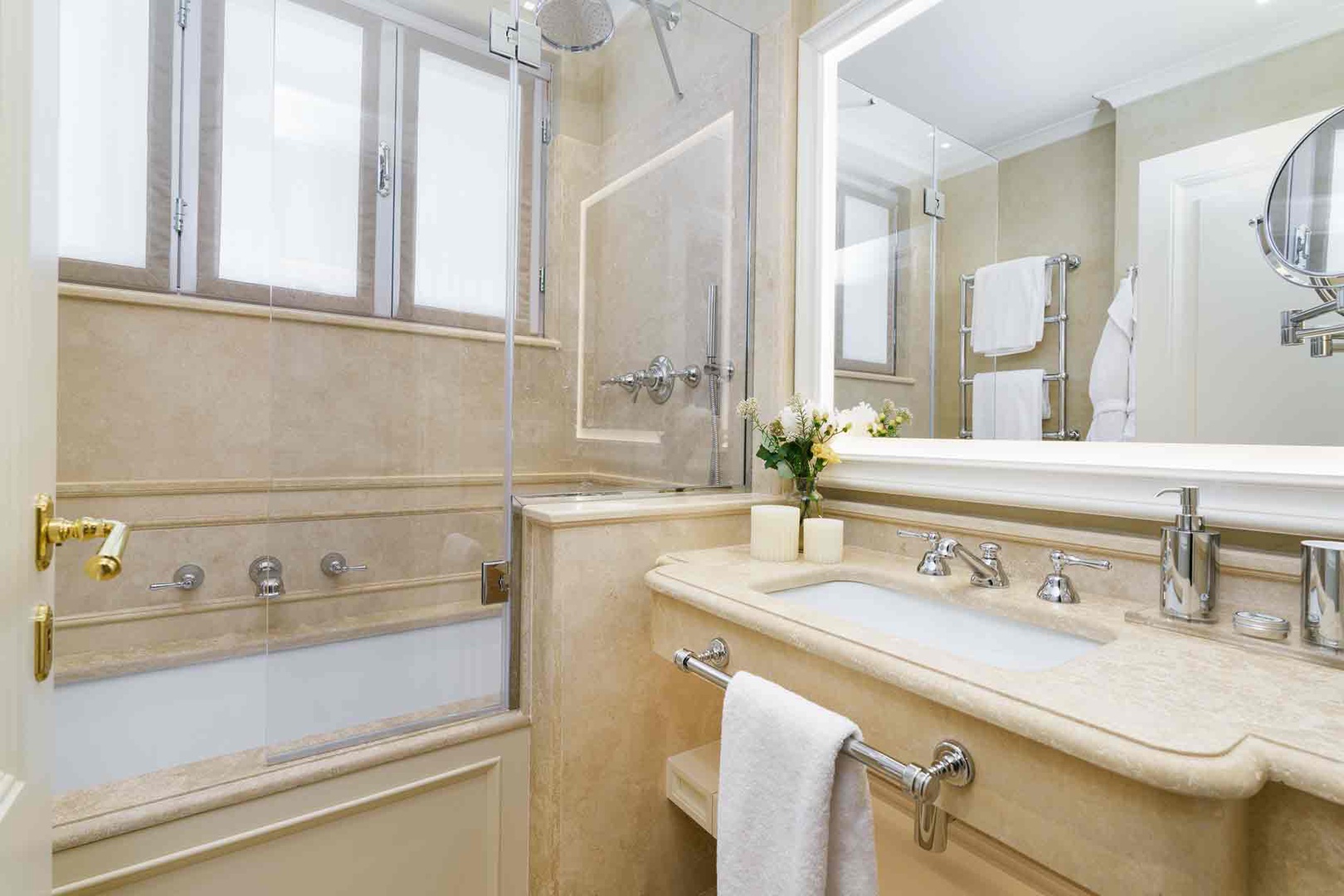 Bathroom 3 features elegant marble surfaces, shower, and a luxurious soaking tub .