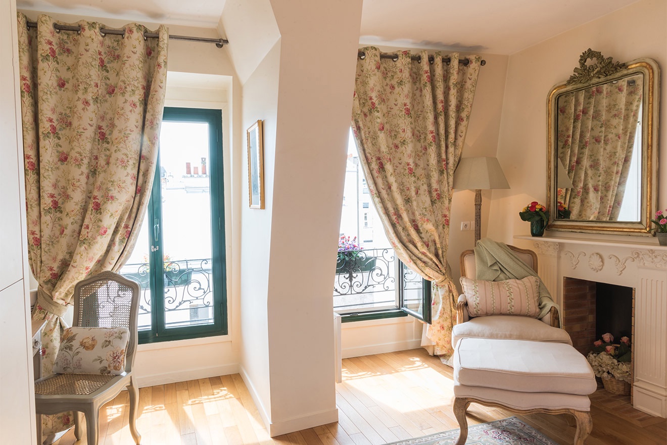 Large French windows in bedroom provide plenty of sunlight.