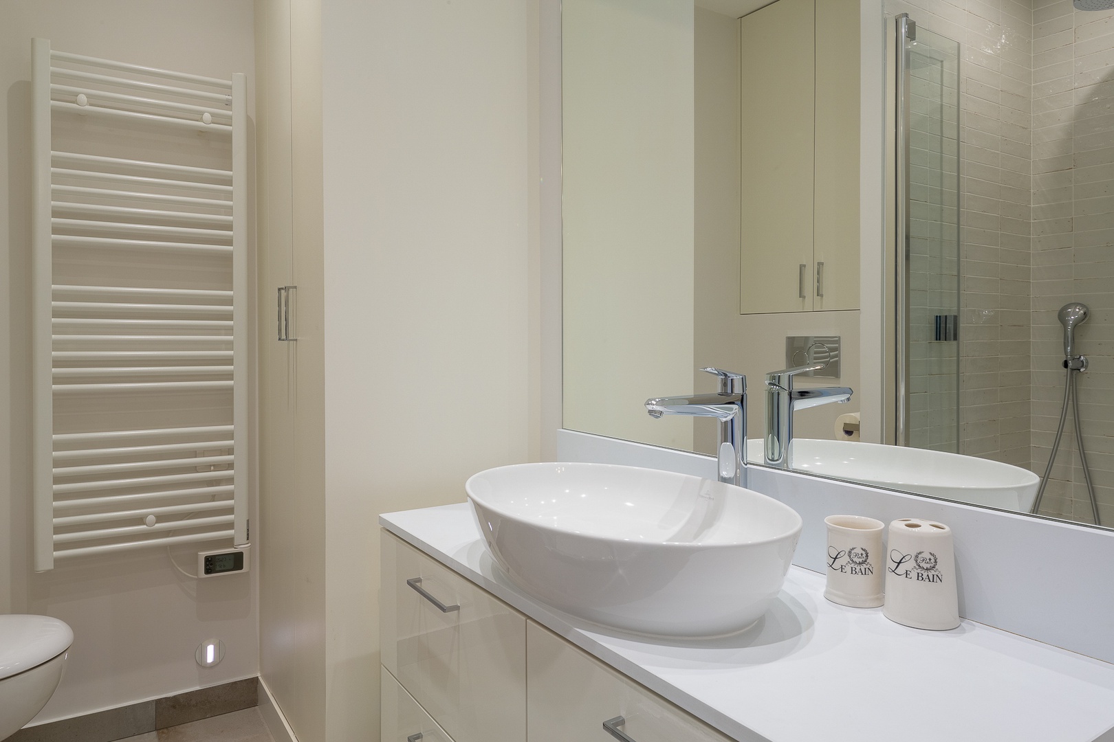 The en suite bathroom 1 comes with a shower, toilet, sink and storage.