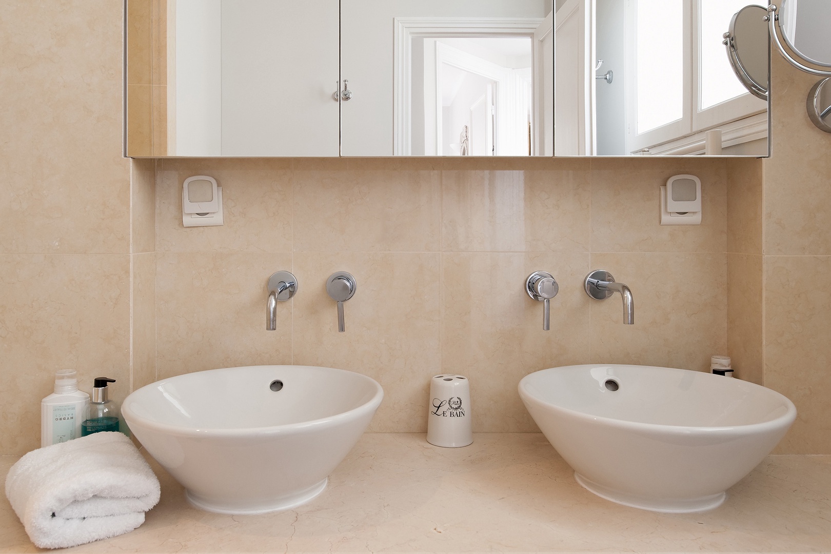 Enjoy double sinks and plenty of storage space in bathroom 2.