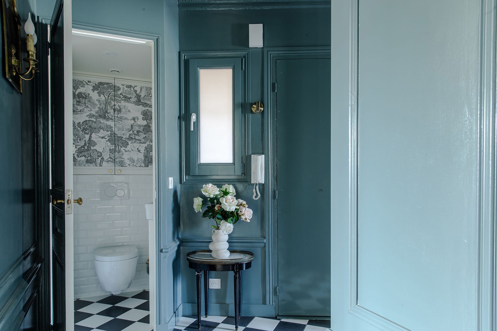 Additional powder room located in entryway.