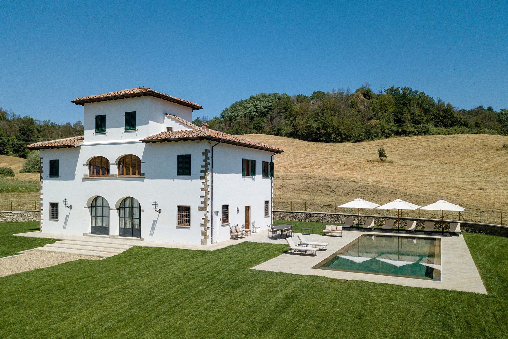 A fully renovated luxury villa in a scenic rustic Tuscany setting.