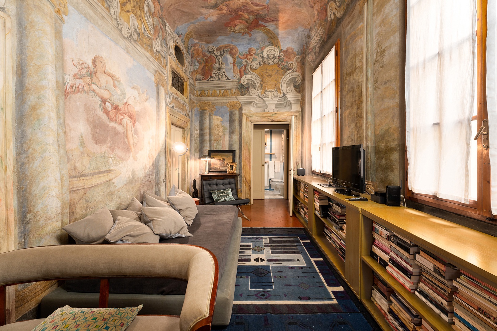 The study glows with bright frescoes.