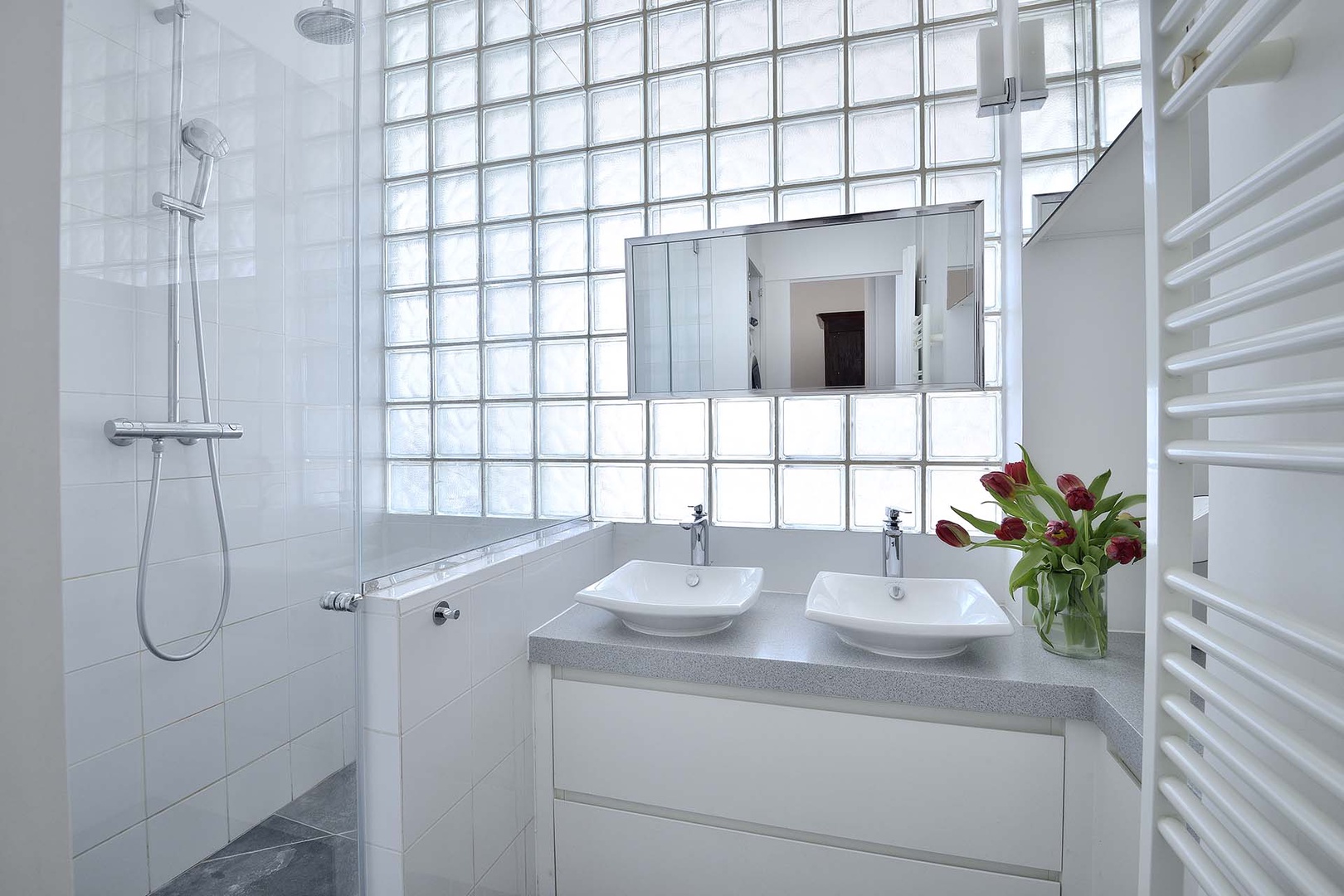Double sinks and shower in the bathroom.