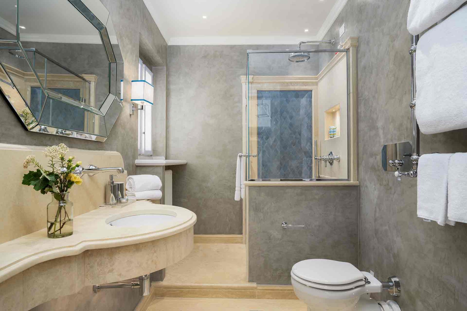 The en suite bathroom 1 features elegant marble finishes, a spacious walk-in shower, and thoughtful touches .