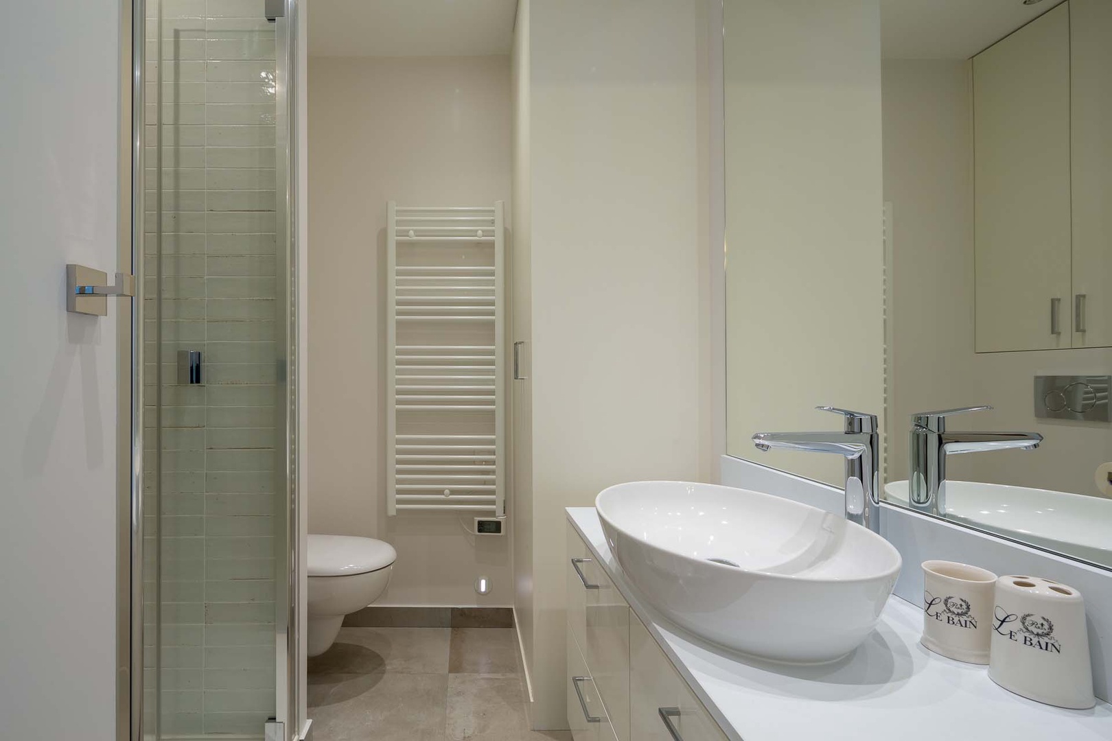 The en suite bathroom 1 comes with a shower, toilet, sink and storage.