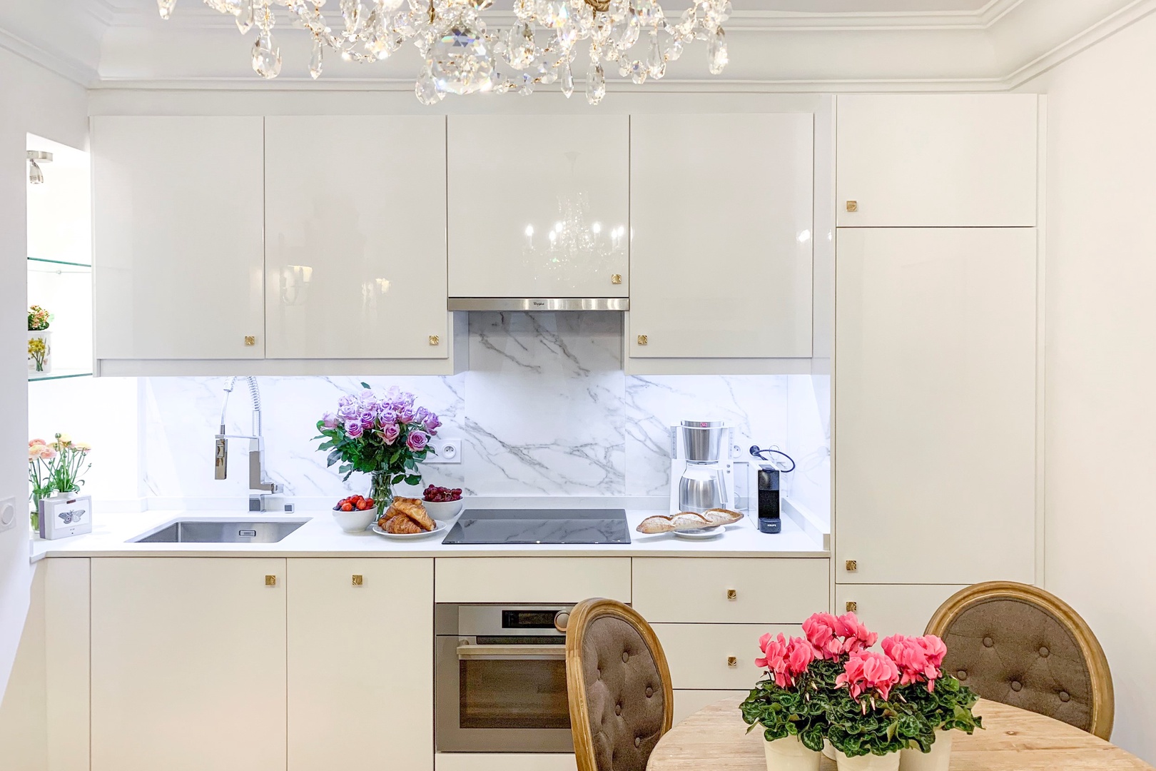 Two beautiful kitchens are well equipped.