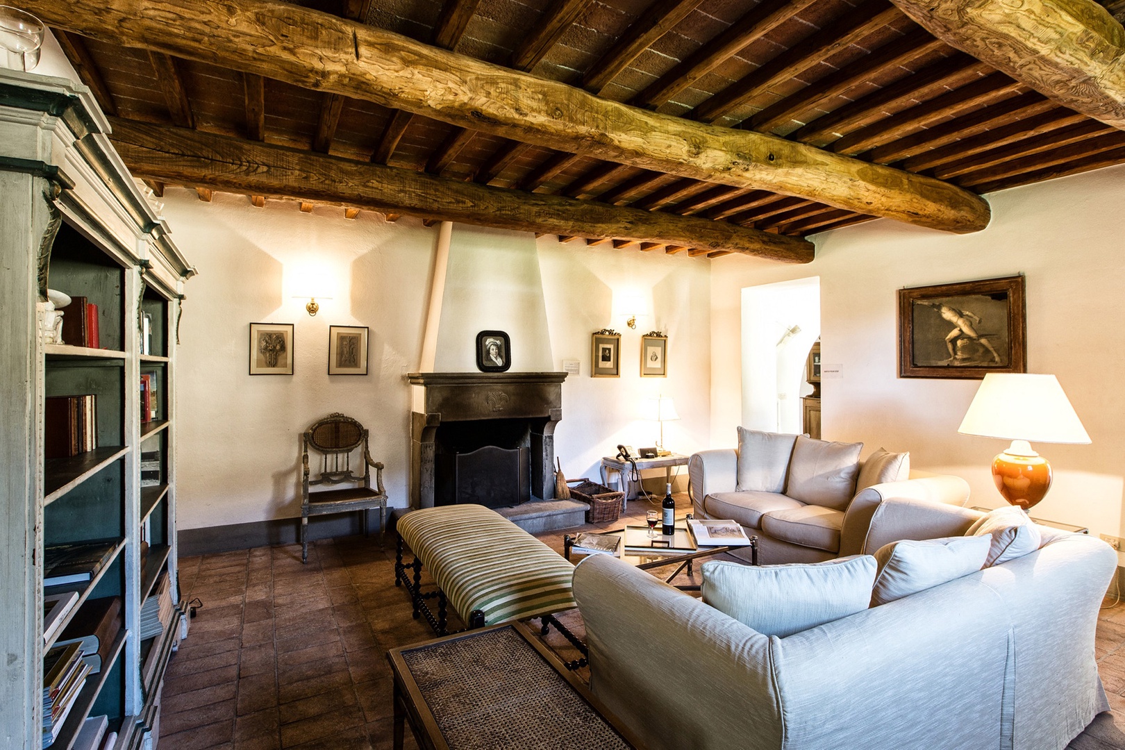 Handsome living room with fireplace in the main house.