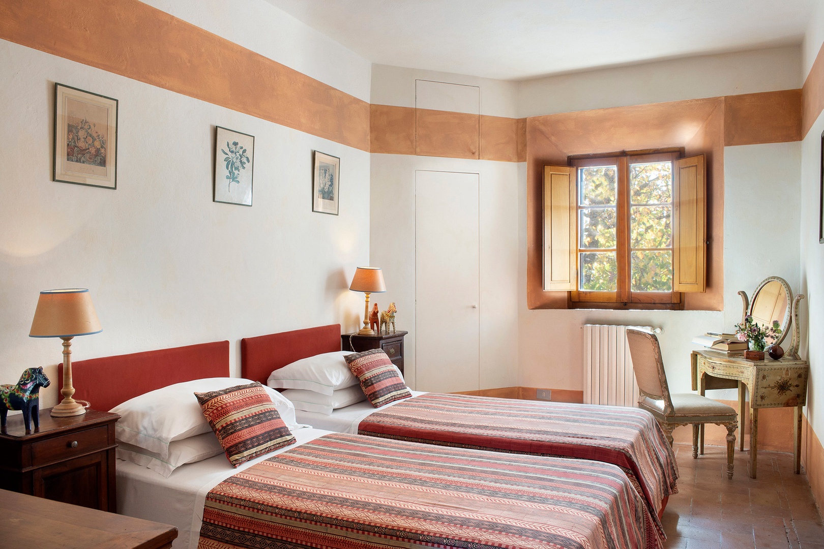 Bedroom 3 with two beds and antique dresser.