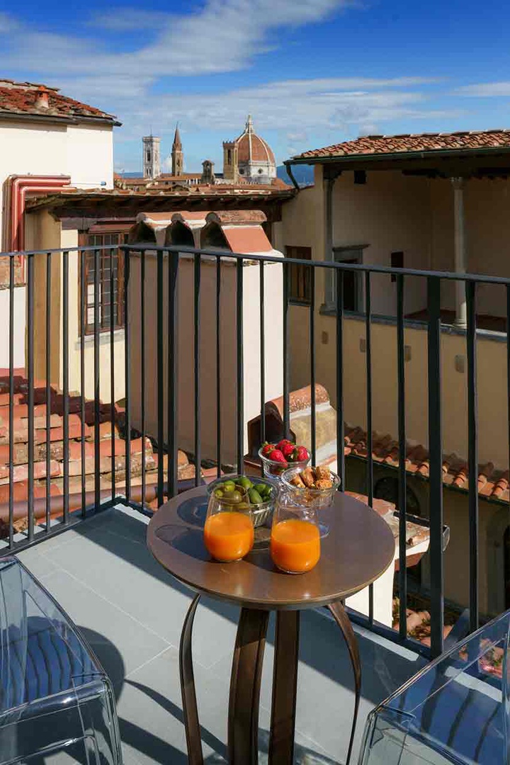 Start your mornings on your private balcony where you can see the tip of Santa Croce in the distance.