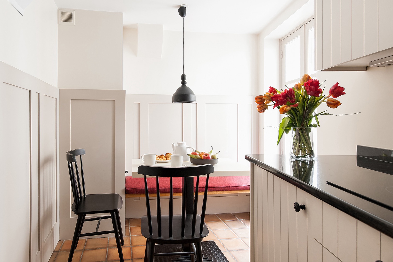 The dining area features a clever built-in bench seat.