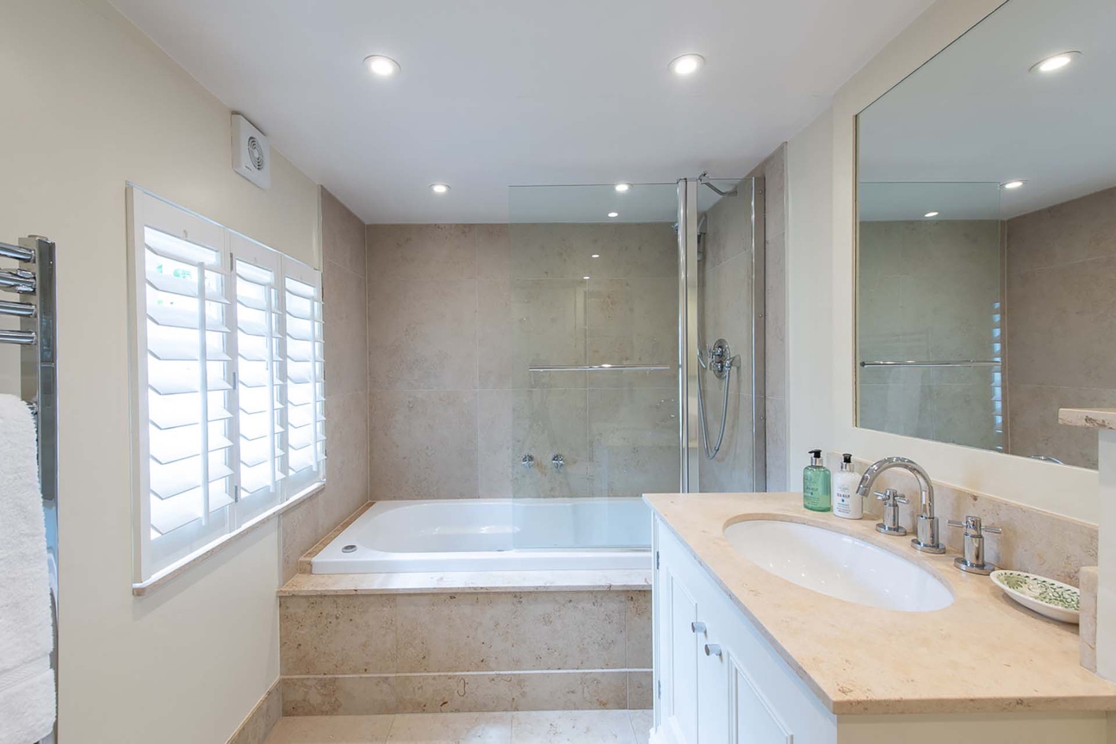 Beautiful large bathroom with bathtub and shower combo.