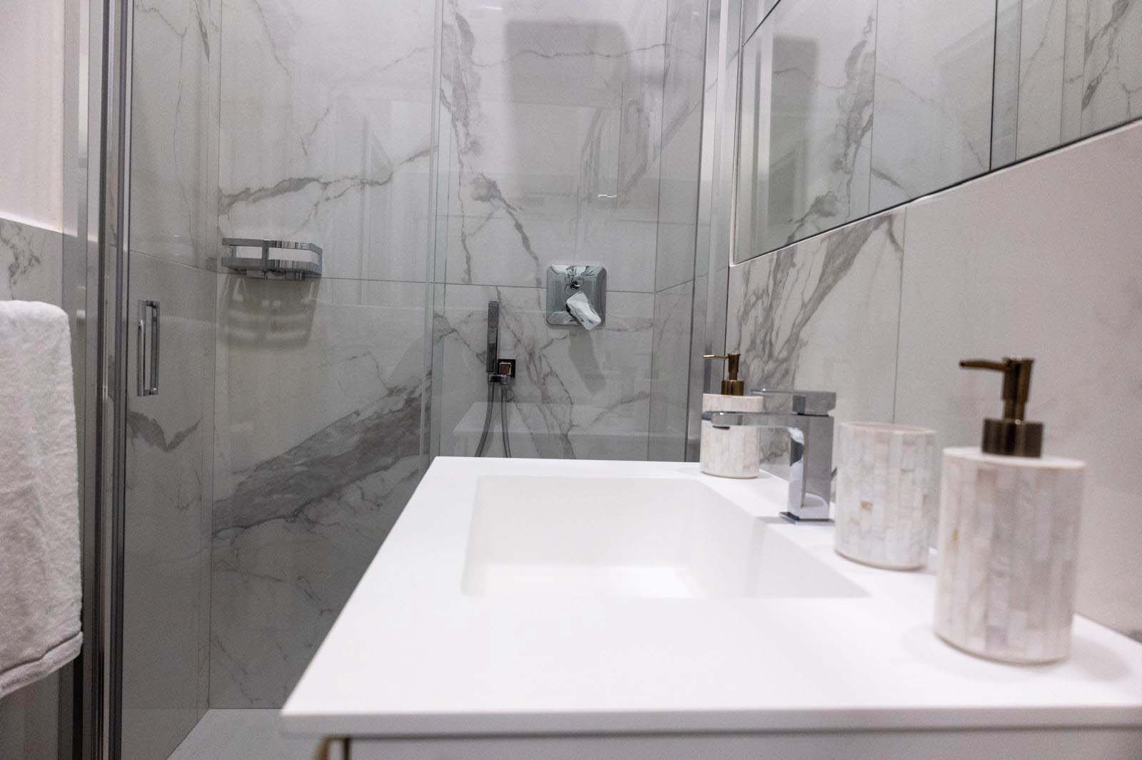 Marble lined shower in the bathroom.