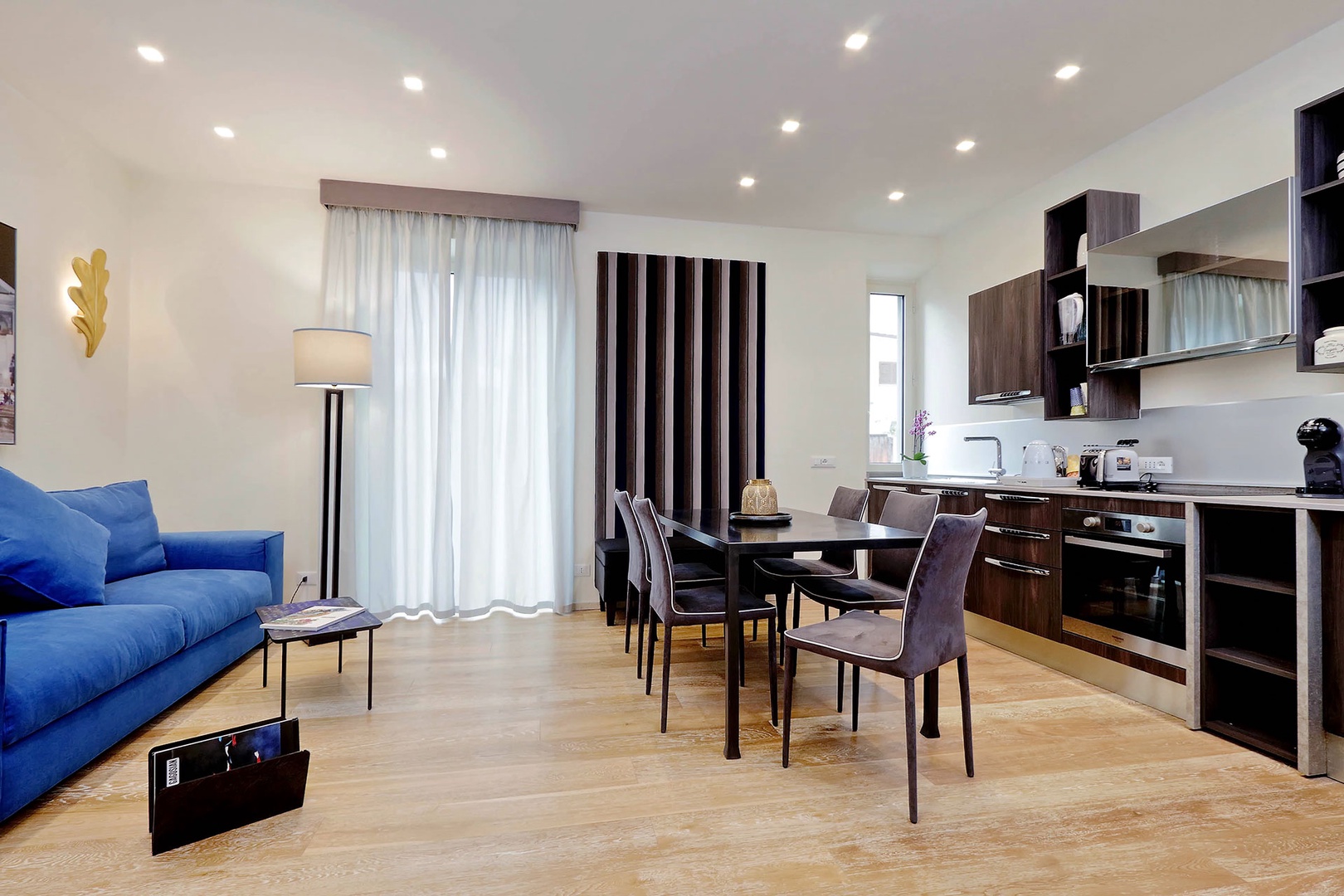 Well-designed open plan living area with doors to step out balcony.
