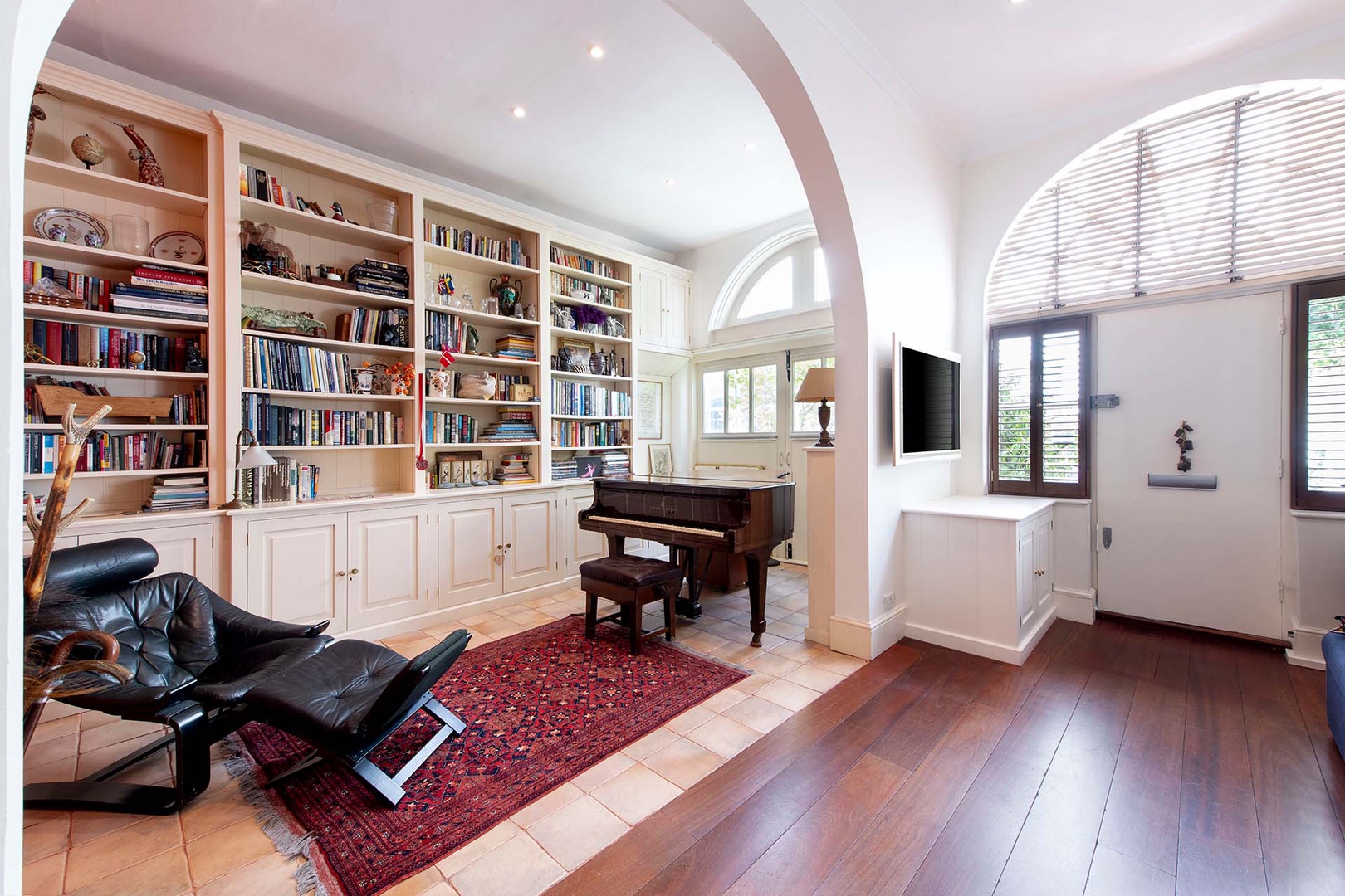 Library sitting area opposite the living room. Piano not for guest use.