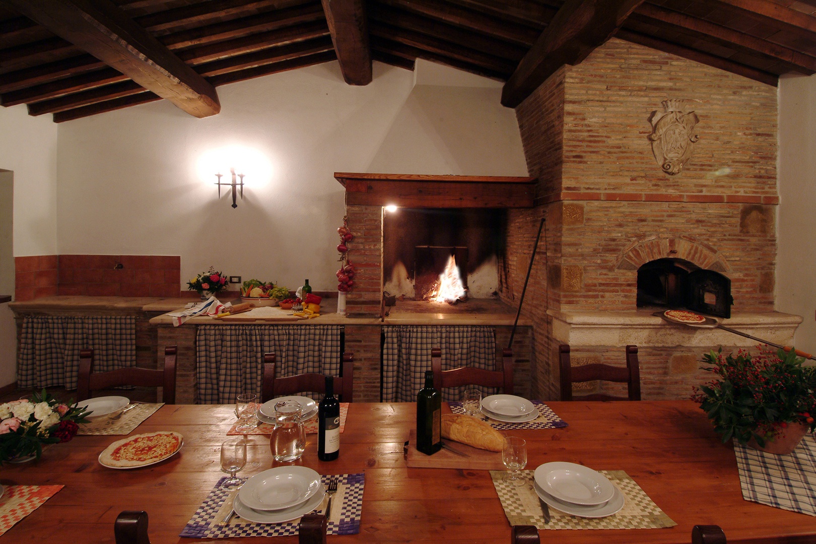 Covered dining space with fireplace, pizza oven and BBQ  for enjoying Tuscan sunsets