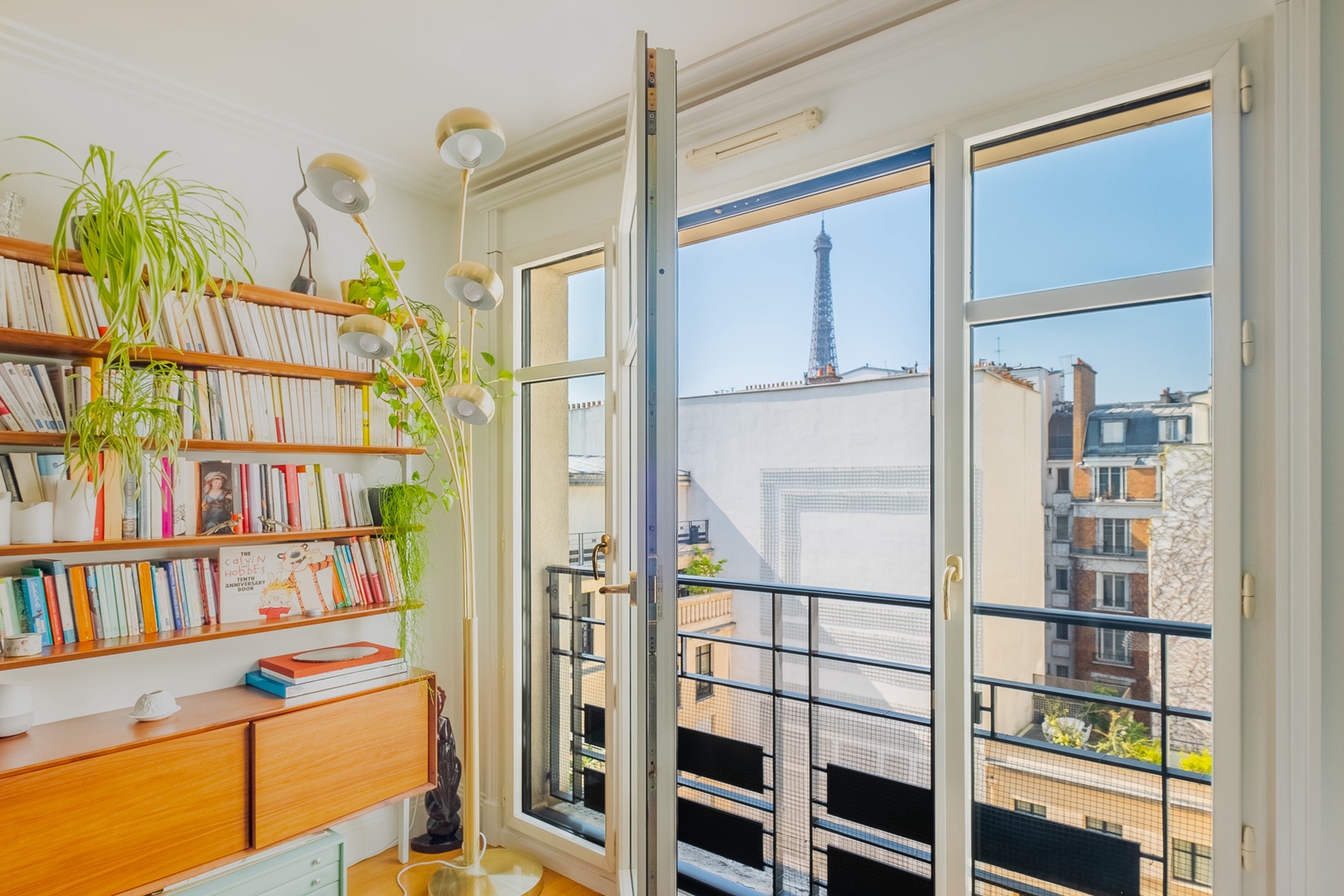 Enjoy the view of the Eiffel Tower peaking over rooftops.