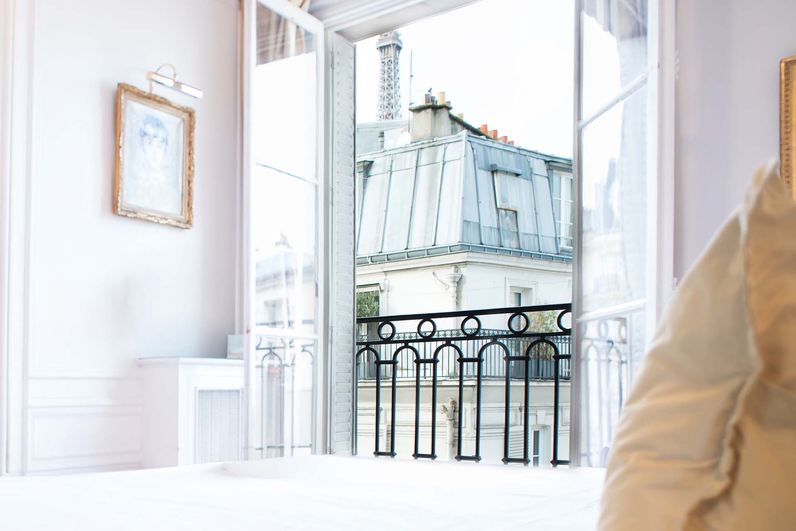 View of the Eiffel tower peaking over the buildings from the third bedroom.