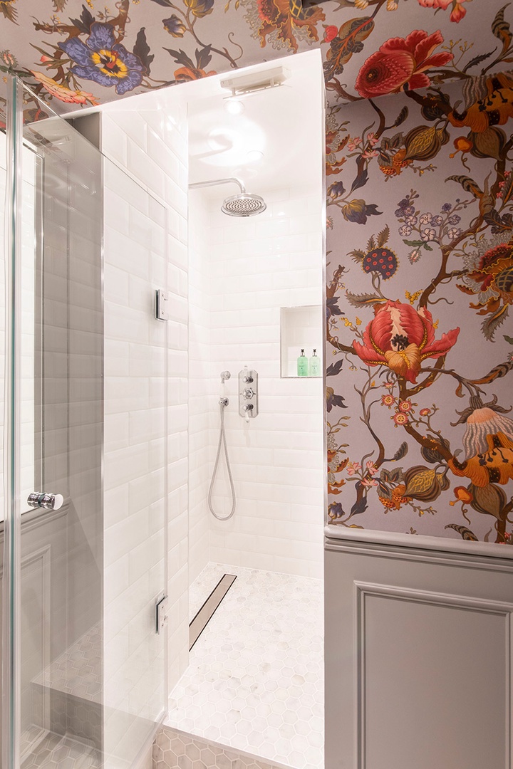 Shower and vibrant wallpaper in bathroom 3.