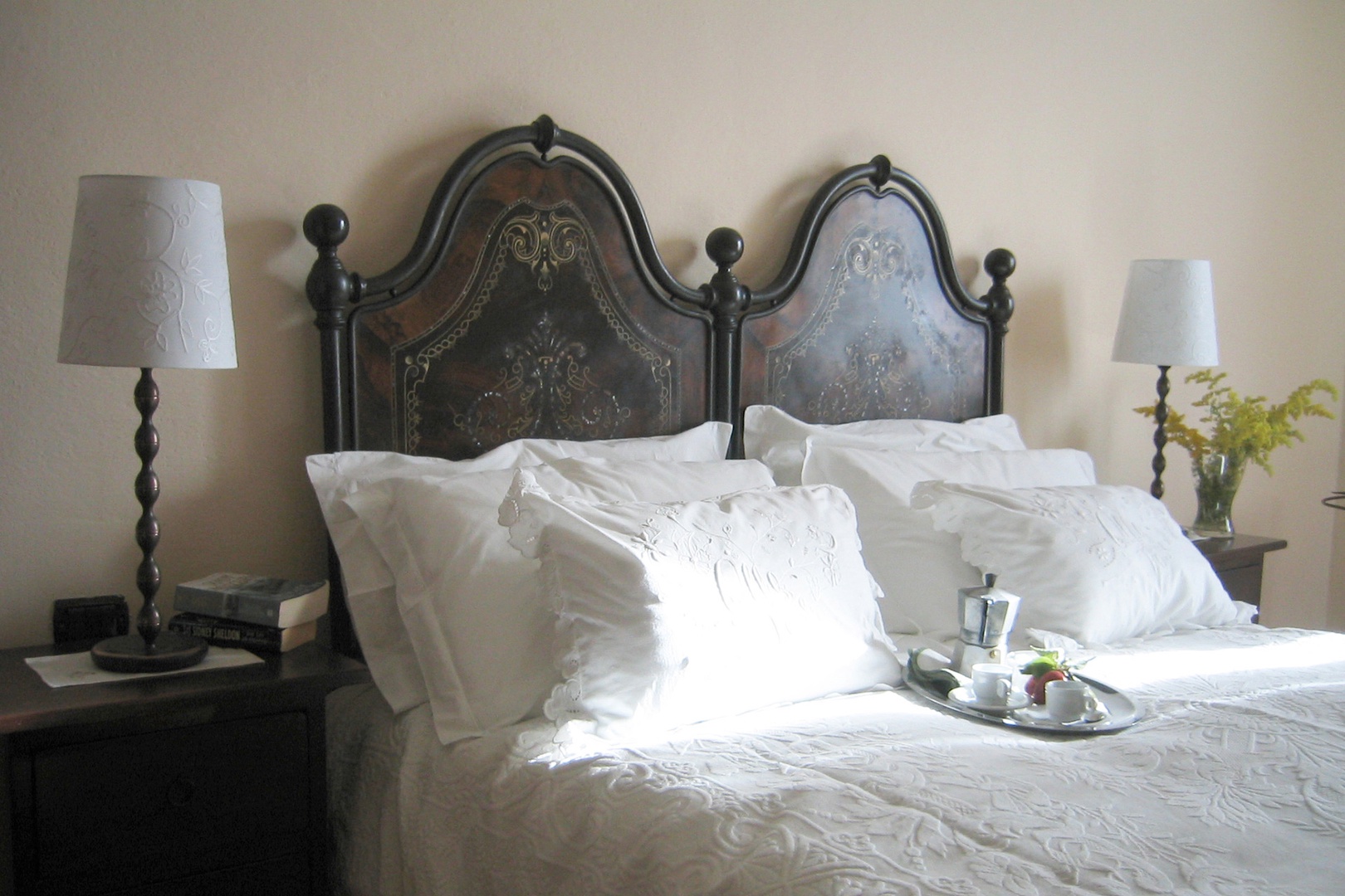 Morning sun streams into bedroom 2 with beautiful antique headboard.