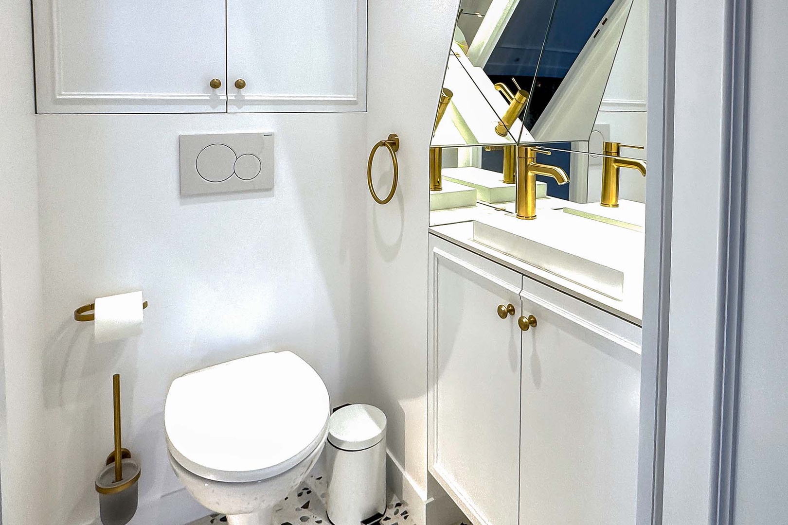 Additional powder room with toilet and sink is convenient for guests.