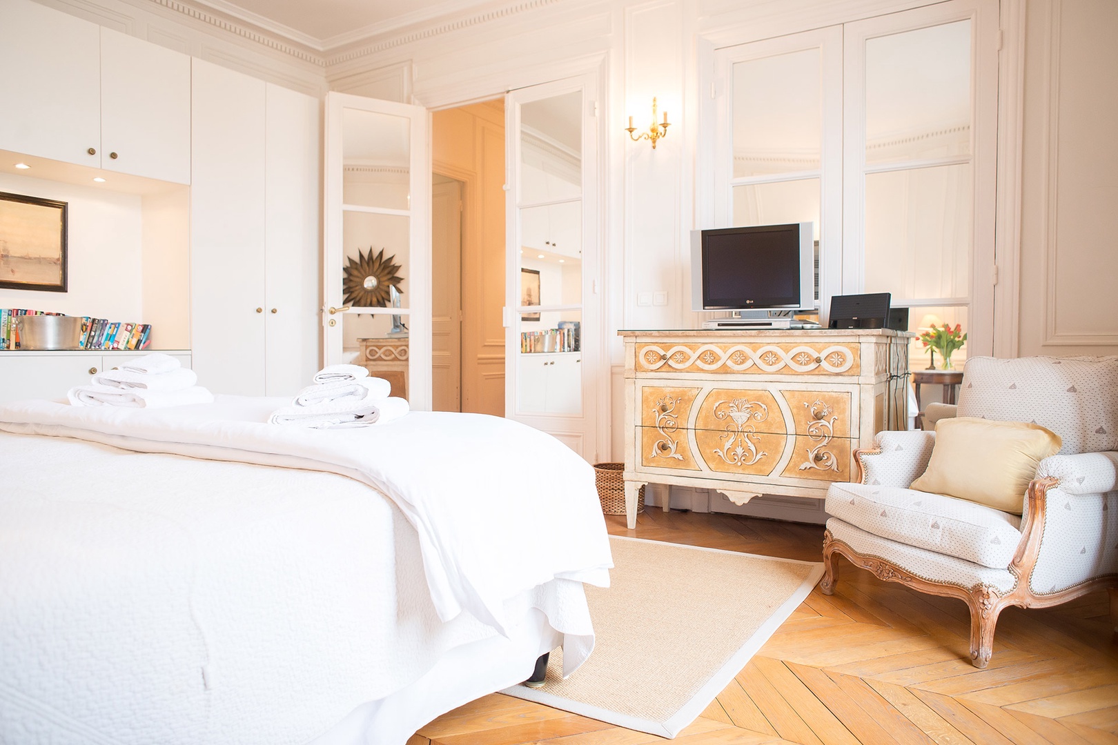 The oversized French door brightens the bedroom.