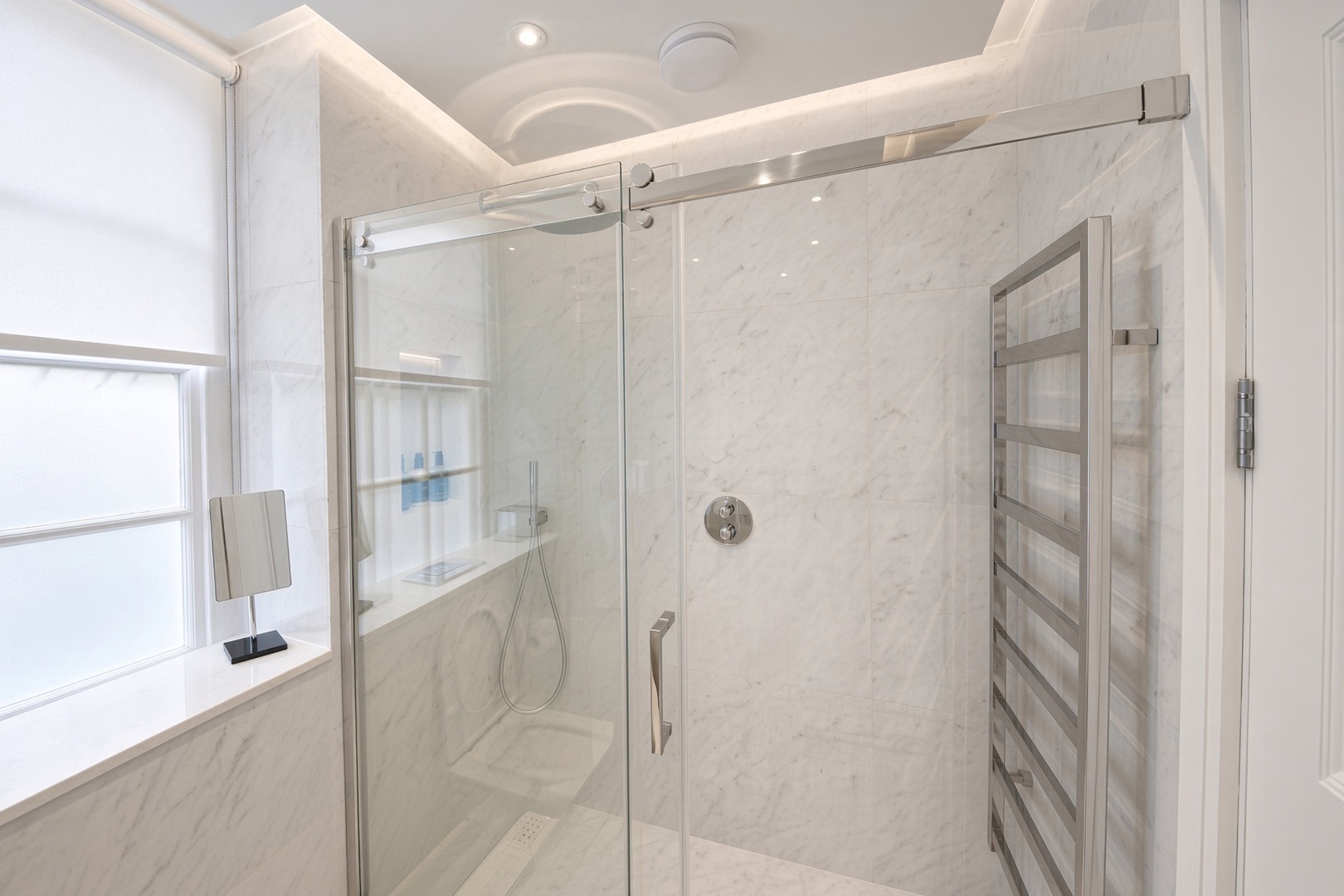 Bathroom has toilet, sink and large shower.