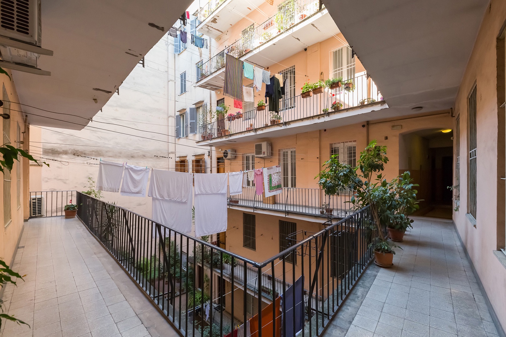 Laundry in courtyard provides authentic Roman living experience.