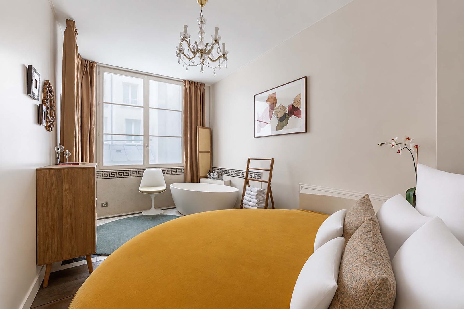 Bedroom has freestanding bathtub.