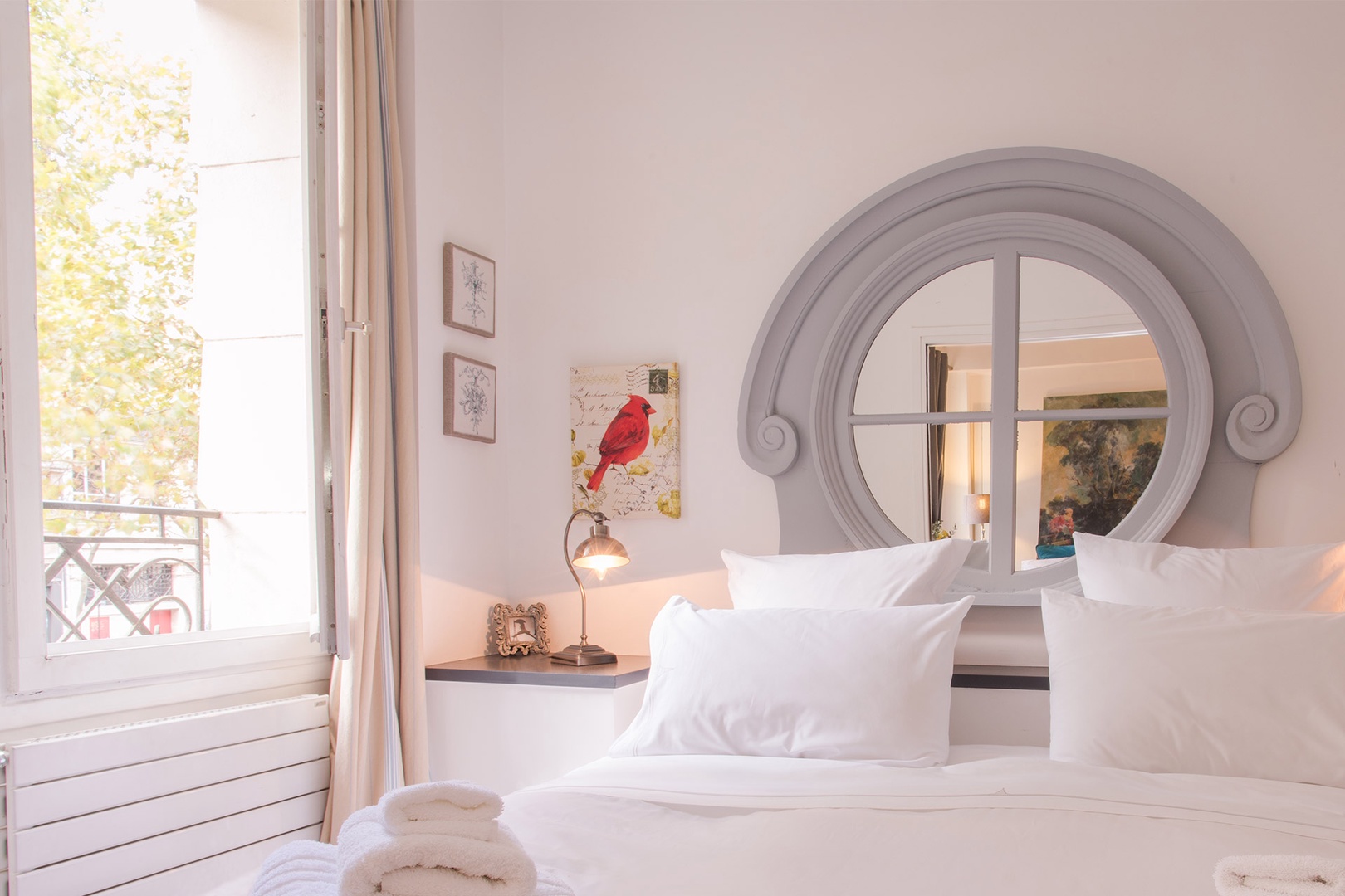 Large windows let lots of light into the lovely Parisian bedroom.