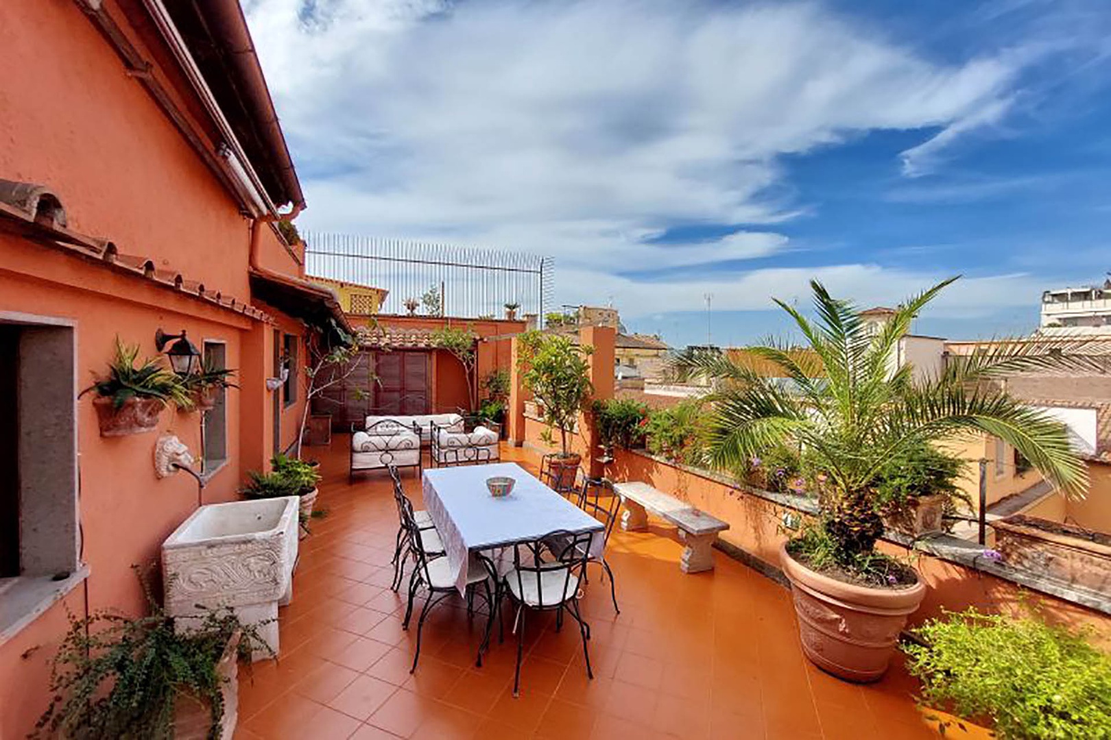 Dine al fresco on the expansive terrace overlooking the rooftops of Rome.