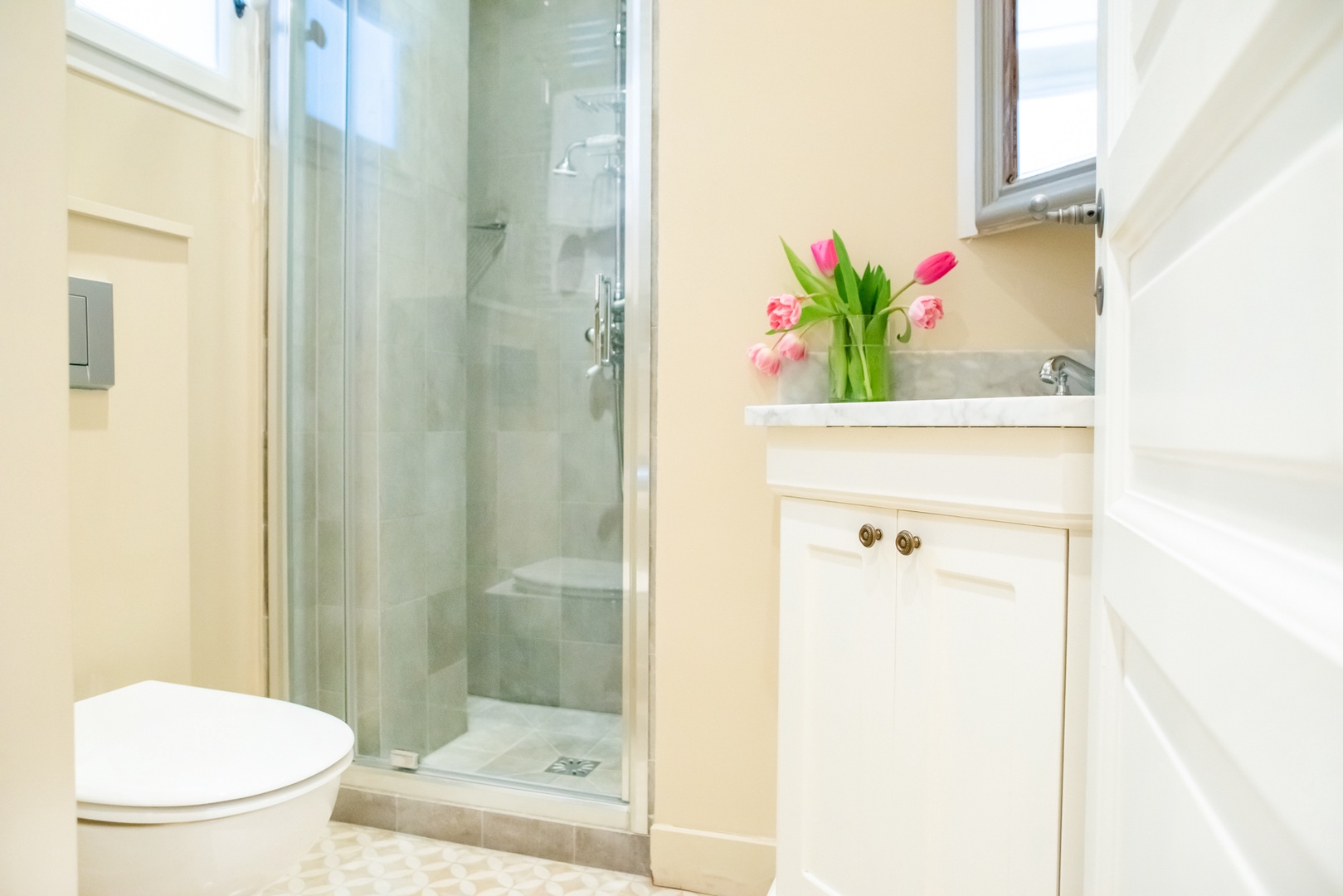 Next to bedroom 2, you'll find a separate bathroom with a shower and heated towel rack.