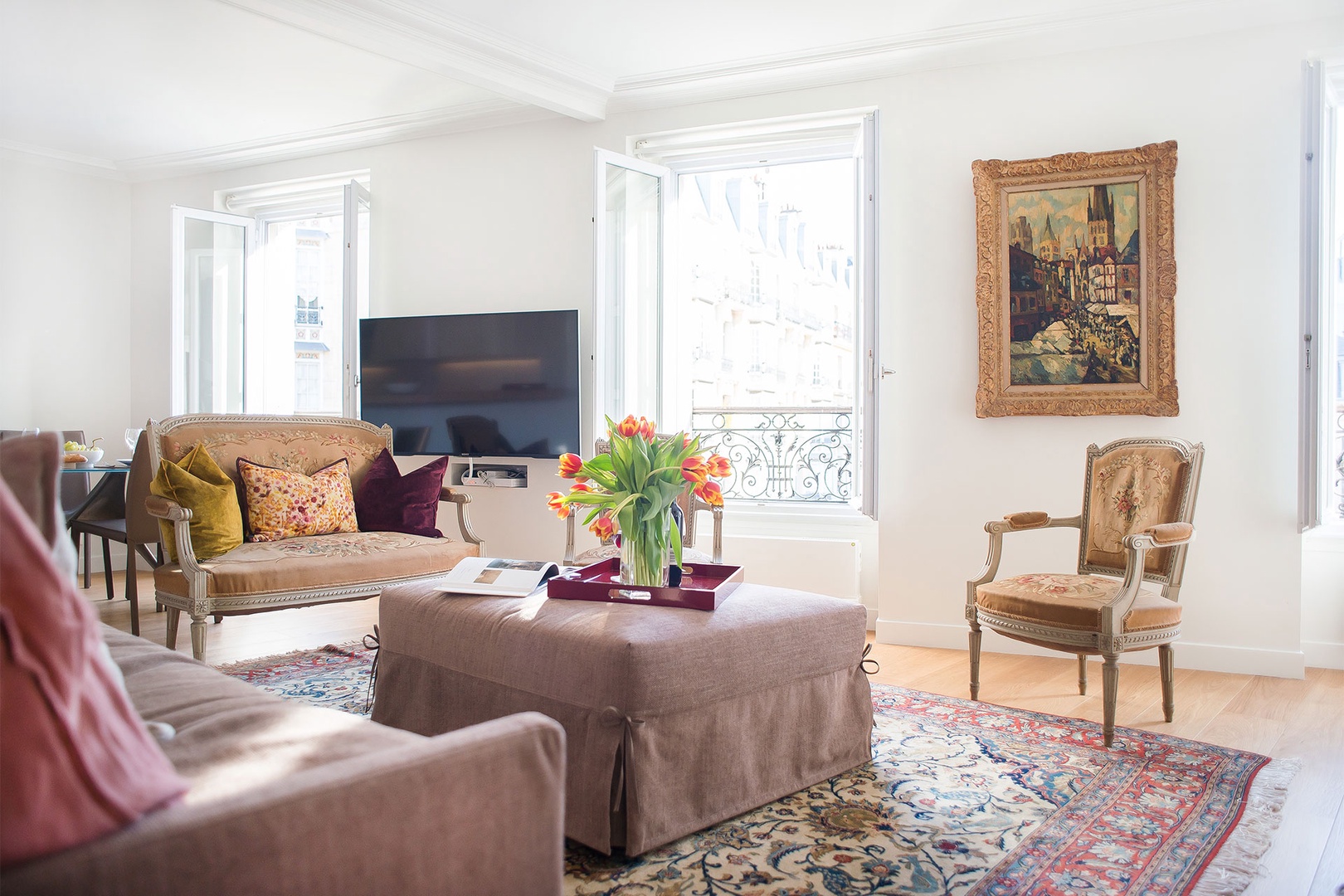 The apartment has been decorated with a mix of antiques and modern furnishings.