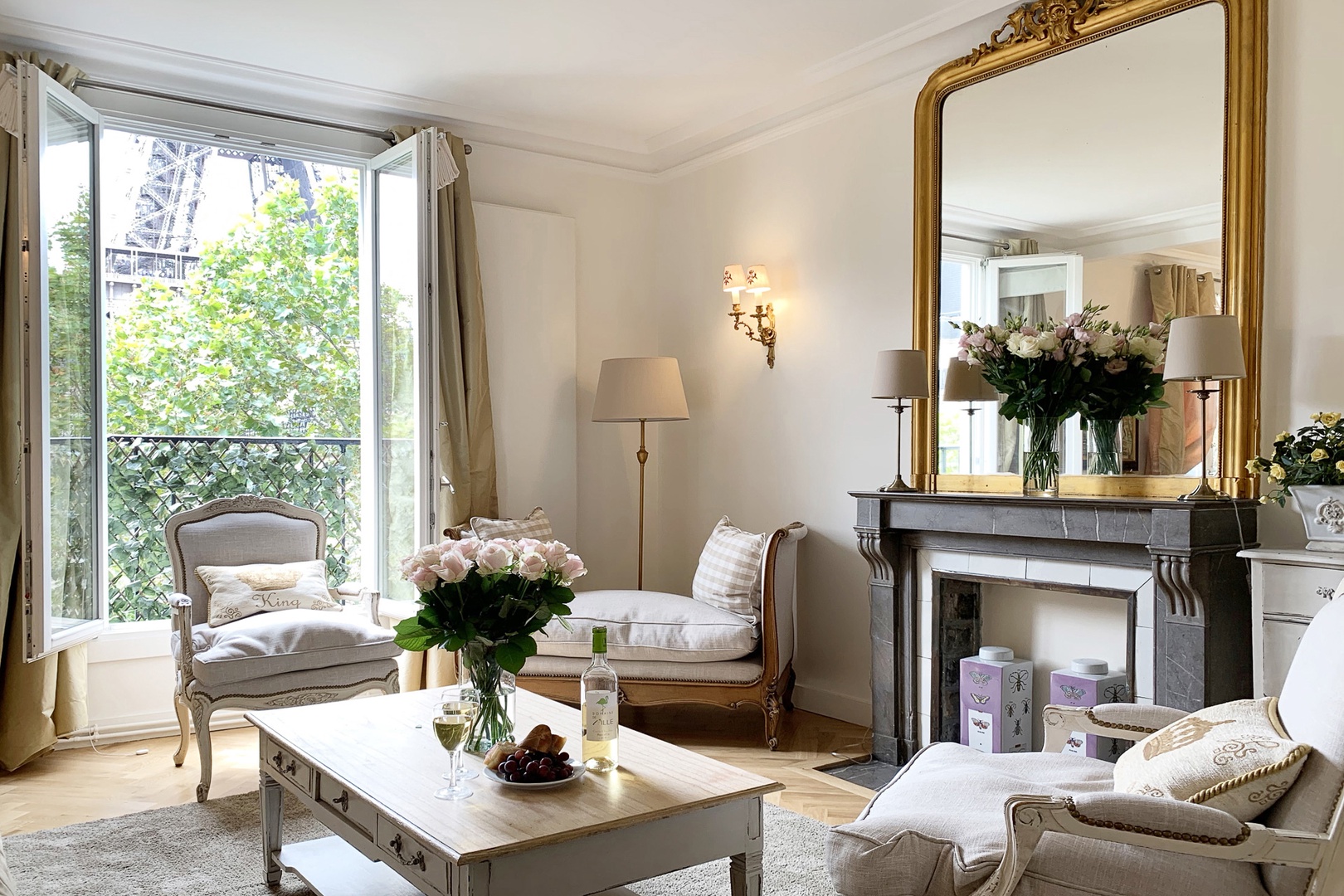 Decorative marble fireplace with a large mirror reflecting lots of natural light.