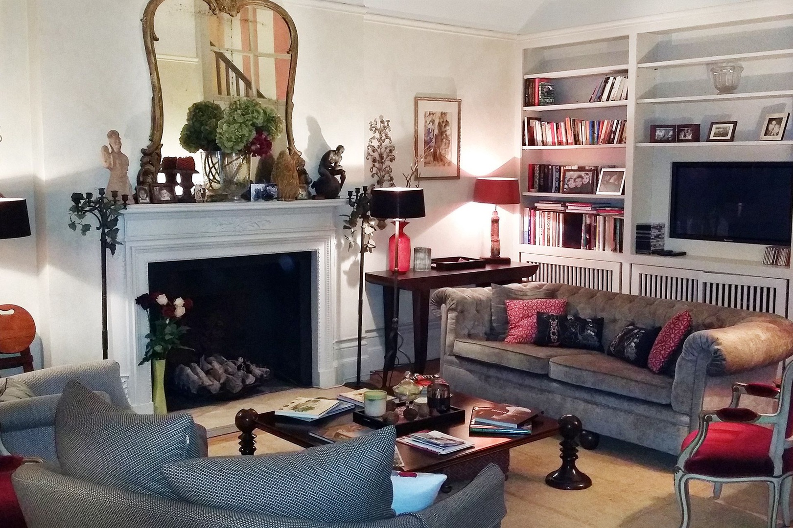 Cozy and spacious living room with fireplace and antique mirror