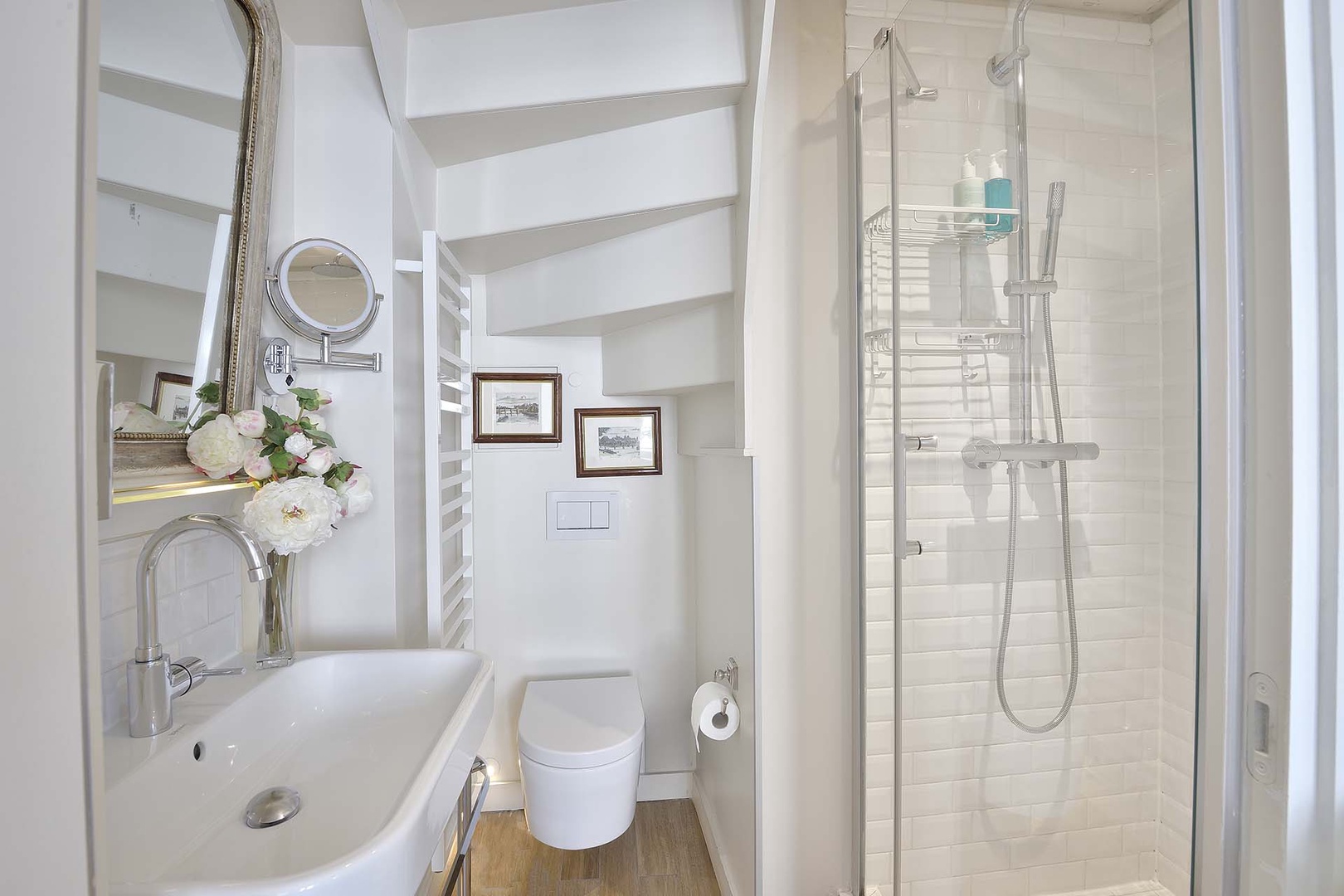 The modern bathroom features a shower, toilet and sink.