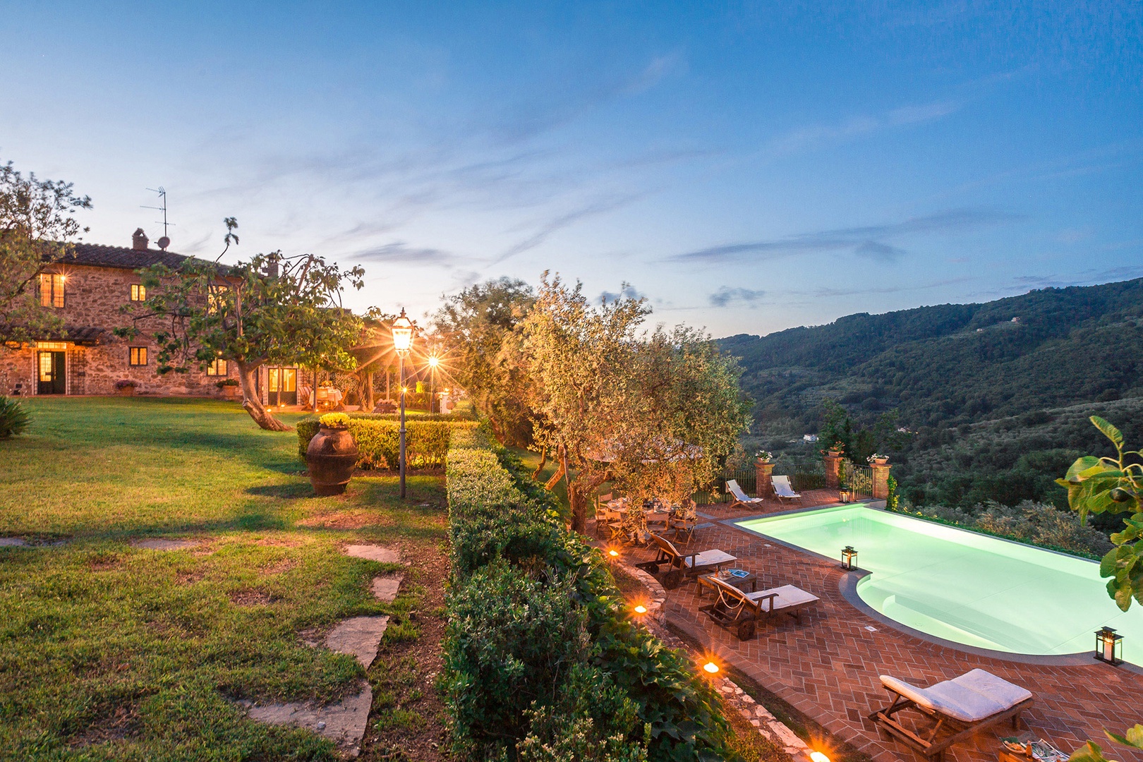 View of pool from lawn behind the property.