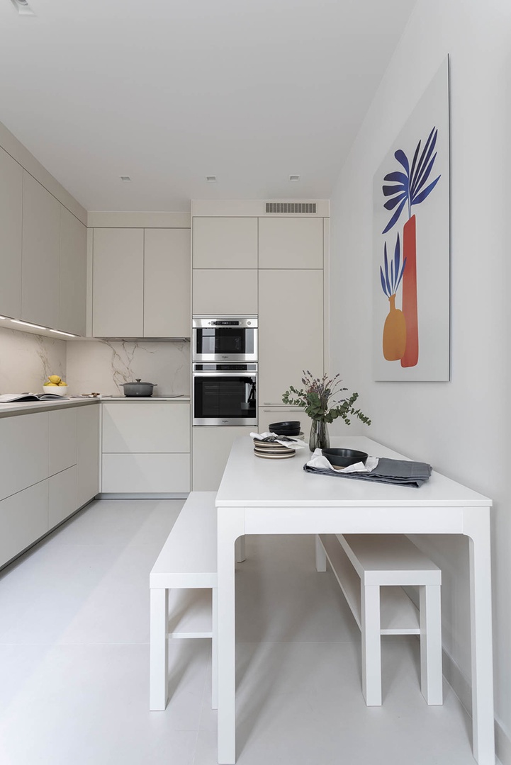 The large kitchen has a table with benches.