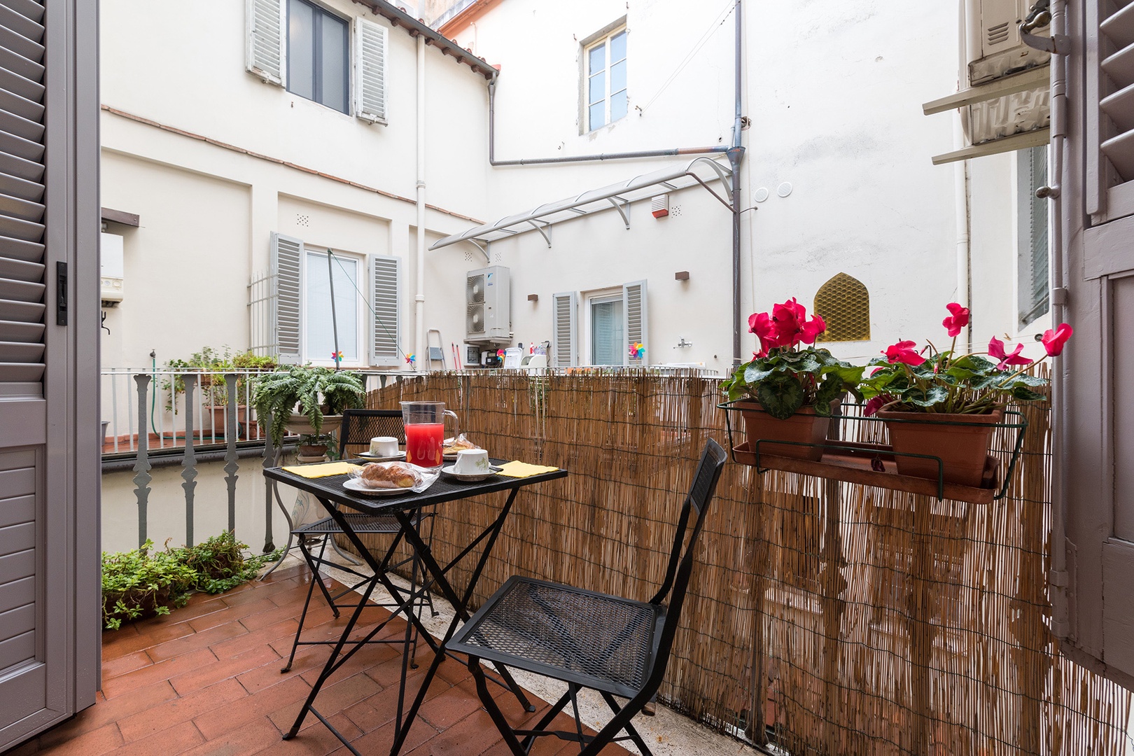The small terrace provides a sunny retreat. It faces the back of the neighboring apartments.