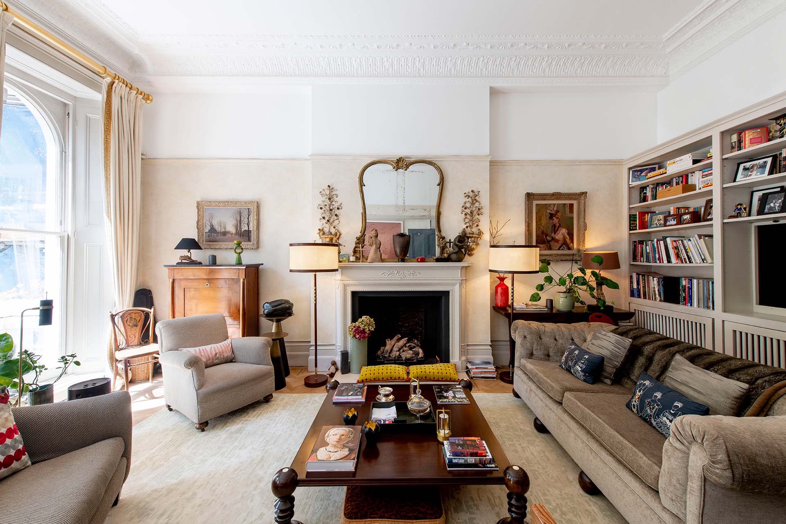 Cozy living room with fireplace and antique mirror.