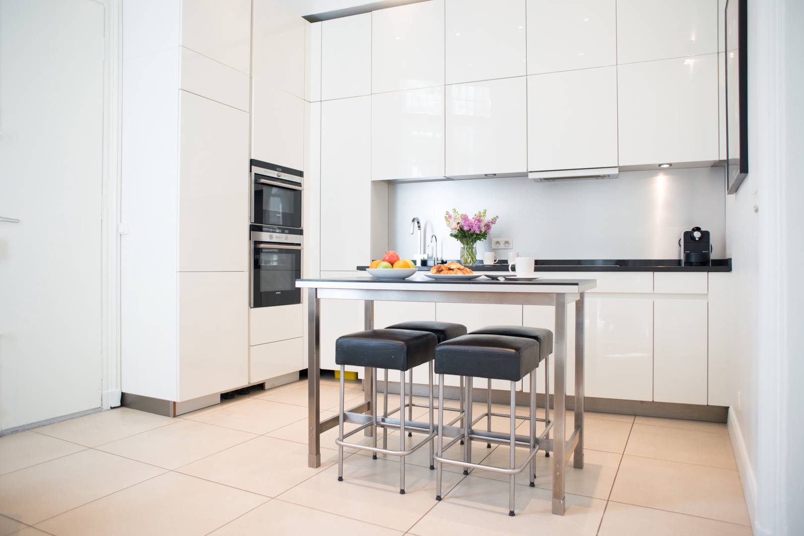 The beautiful modern kitchen is just off the living room.