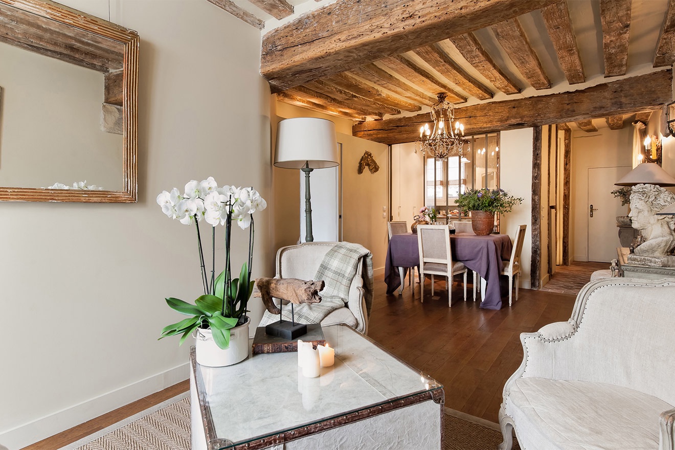 The stunning apartment features original elements, such as wooden beams.