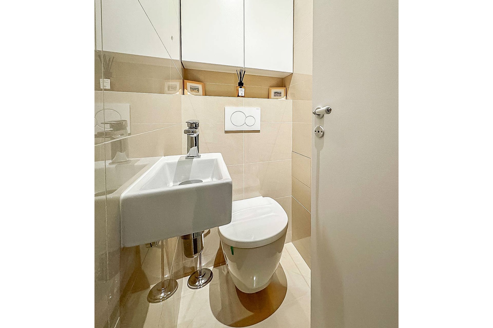 Separate powder room with toilet and sink.