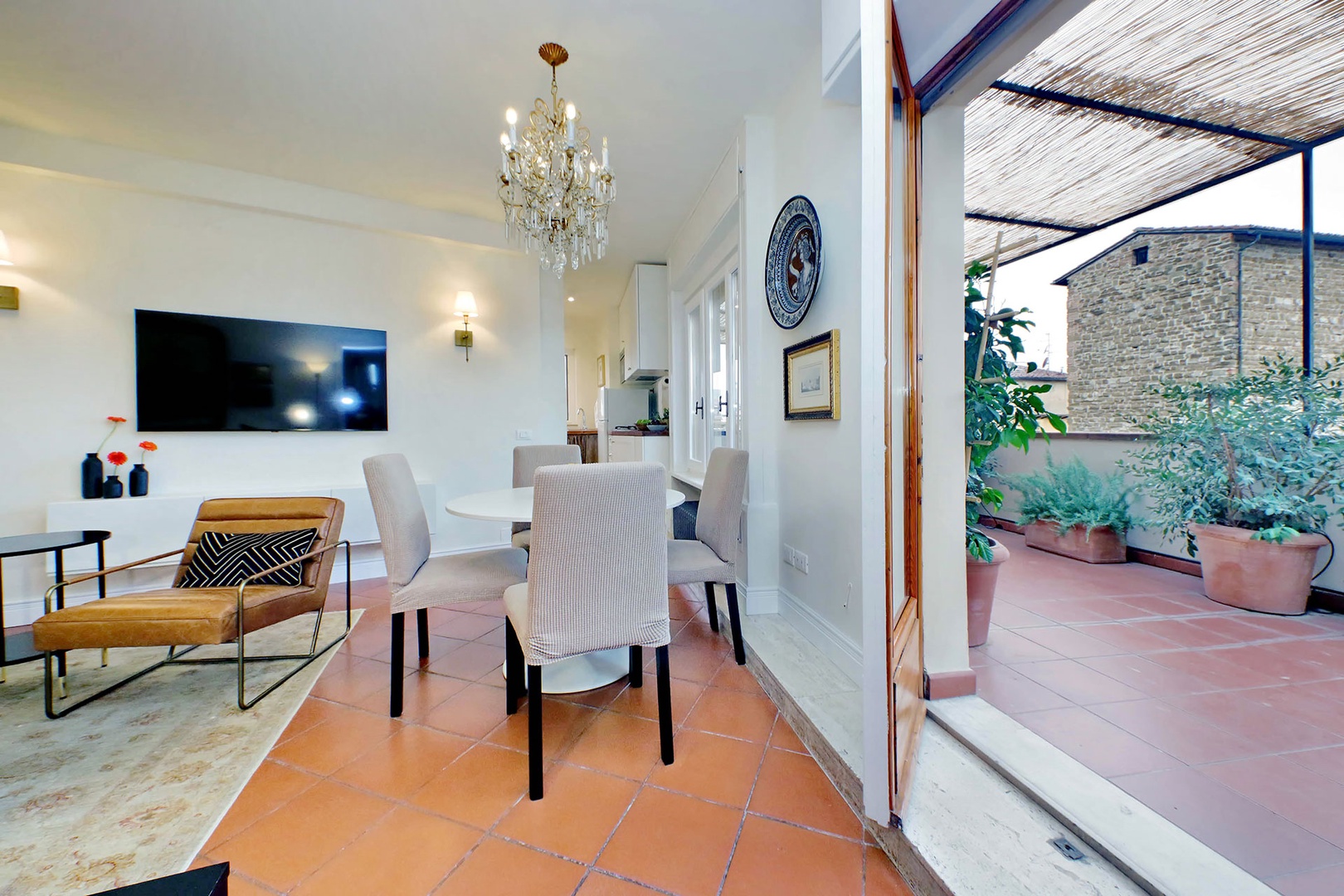 Large French doors open off the dining area to the expansive terrace.