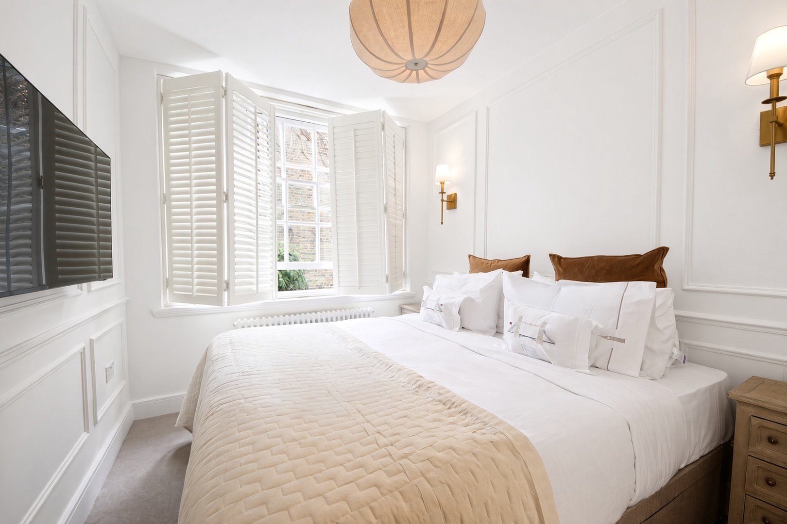 Bedroom 1 has large window and wall-mounted TV.