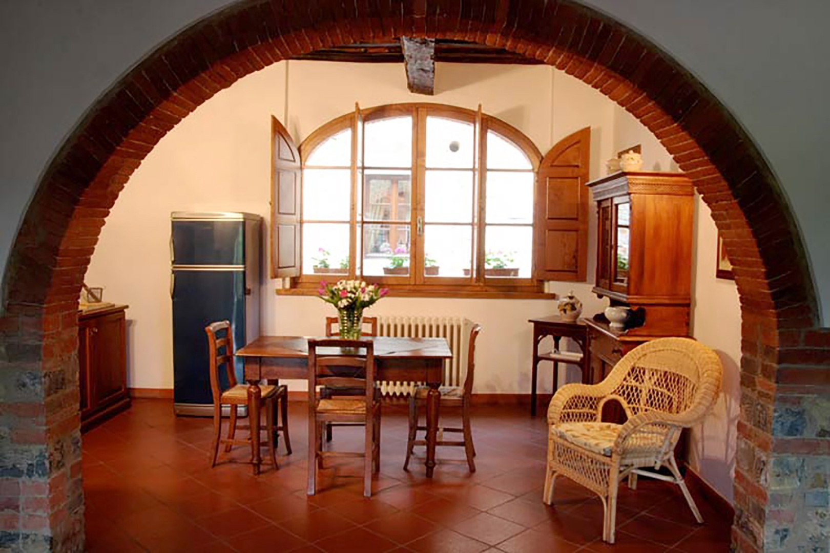 An archway opens between the living room and the dining area with kitchenette.