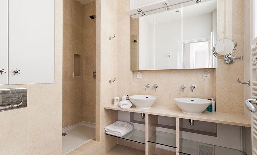 Bathroom 2 with shower, double sinks, toilet and heated towel racks