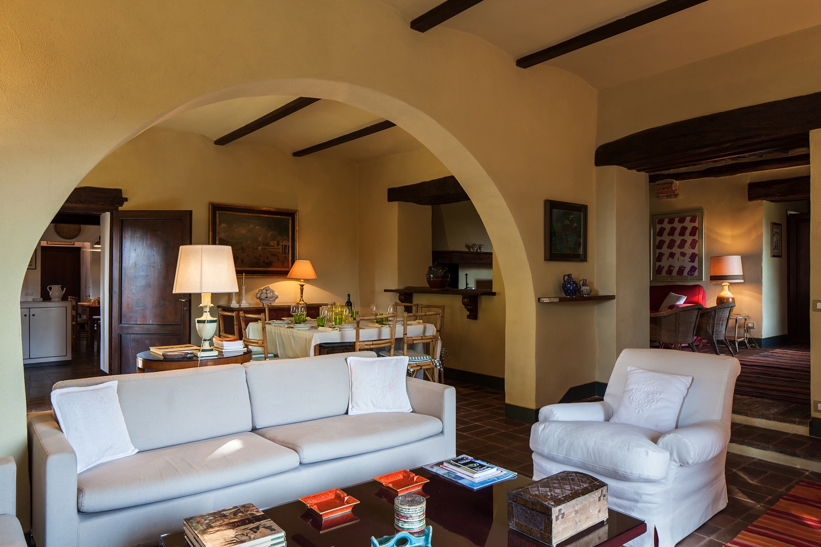 The living room of L'Albero is at the heart of the house and has windows that open onto the garden.